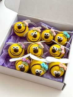 a box filled with yellow cake covered in frosting and decorated to look like bees