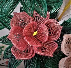 a close up of a flower made out of beads