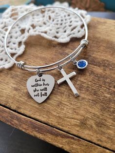 ❤ Item details : beautiful stainless steel laser etched bangle bracelet❤ Charms : * stainless steel laser etched " god is within her she will not fall" charm* cross charm * your choice of 7mm birthstone gem ❤ My stainless steel bangles are expandable, non-tarnishing and perfect for those with sensitivity to certain metals.❤ 3 sizes to choose from : Small 6"-7" wrist Medium 7-8" wrist Large 8-9" wrist ❤ Packaging:Your order will be sent in a beautiful organza bag. You can upgrade to "gift wrap" a Inspirational Nickel-free Stainless Steel Jewelry, Stainless Steel Cross Bracelet As A Gift, Stainless Steel Cross Bracelets As Gifts, Stainless Steel Cross Bracelet As Gift, Cross Shaped Stainless Steel Bracelet As Gift, Cross Shaped Stainless Steel Bracelet Gift, Camera Jewelry, Confirmation Jewelry, Camera Necklace