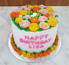 a birthday cake decorated with flowers and the words happy birthday usa on it's side