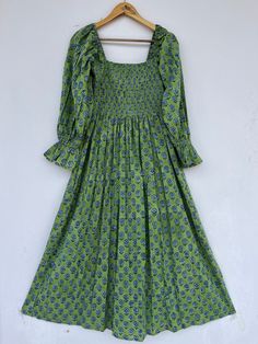 "block printed dress, hippie dress, vintage gown, floral dress, boho dresses, smocked maxi, long dress, long maxi, beautiful dresses, stylish maxi, unique dresses, indian cotton dresses seller, dresses with pockets, comfortable maxi, holiday wear dress, floral dress, block print dress, long maxi, cotton maxi, floral maxi, partywear dress, green maxi, bohemian dresses Feel beautiful and confident throughout your days wearing our block printed outfits, made with high quality soft and breathable cotton fabric.  The print on the dress is known as \"BLOCK PRINT\" which is centuries old technique of Indian textile carried out  by local artisans of Jaipur (INDIA) MEASUREMENTS (in inches): Size XXS-: Bust- 34″ | Shoulder- 13.5″ | Length- 51″ Size XS-: Bust- 36″ | Shoulder- 14″ | Length- 51″ Size S Bohemian Smocked Midi Dress, Green Bohemian Dress With Smocked Back, Green Bohemian Midi Dress With Smocked Bodice, Bohemian Maxi Dress With Smocked Bodice, Green Maxi Dress With Smocked Back, Bohemian Long Dress With Smocked Bodice, Block Print Fitted Maxi Dress, Green Bohemian Maxi Dress With Smocked Back, Green Bohemian Maxi Dress With Smocked Bodice