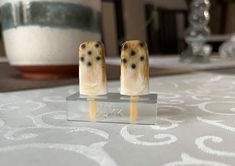 two small candles sitting on top of a table