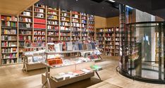 the inside of a book store with many books on shelves and glass cases full of books