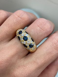 Vintage Dome Ring, 2.10CT Oval Natural Sapphire, 18k Yellow Gold Chunky ring, Estate Jewelry, Blue Sapphire ring, fine jewelry, cluster ring ~~ S e t t i n g ~~ Solid 18k Yellow Gold 10.20 grams Ring Size 6.5US   ~~ Stones ~~ Main Stone: Oval Shape Natural Sapphire In Weight Of 2.10 Ct (Approx.)  Color  - Blue Side Stones: Round Shape Natural Diamond In Weight Of 0.99 Ct (Approx.) Clarity - Vs2 Color  - F Feel free to contact us for inquiries and consultation and special requests. The item will Antique Sapphire Ring, Gold Chunky Ring, Sapphire Antique Ring, Chunky Ring, Blue Sapphire Ring, Dome Ring, Jewelry Blue, Chunky Rings, Domed Ring