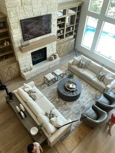 a living room filled with furniture and a flat screen tv mounted on the wall above a fire place