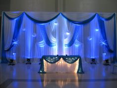 an image of a stage set up for a wedding or special event with blue lighting