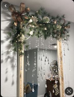 a mirror with christmas decorations hanging from it