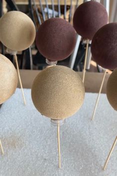 several cake pops are arranged on top of each other in the shape of balls and sticks