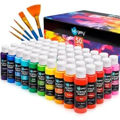 an assortment of acrylic paint bottles and brushes in front of a box with it's contents