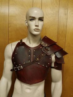 a male mannequin wearing a leather armor with metal rivets on his chest