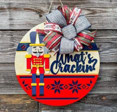 a christmas ornament hanging on the side of a wooden wall with a nutcracker