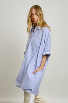 A feminine spin on an oversized button front shirt. Puffable gathered cuff sleeve, shirt pocket and 2 roomy side seam pockets, shaped rolled hem (longer in back) finish this closet favorite. Wear as a short dress, half buttoned over trouser or skirt as styled here, or as an open shirt jacket over jeans for an "I don't care but kinda do look" 100% cotton laundered for easy finish Small Batch Made in Los Angeles | Imported fabric Model is 5"8 and is wearing XS/SM Spring Daywear Shirt With Gathered Sleeves, Spring Shirt With Gathered Sleeves For Daywear, Oversized Shirt Dress With Roll-up Sleeves For Daywear, Striped Cotton Shirt Dress With Relaxed Fit, Button Front Shirt, Rolled Hem, Cuff Sleeves, Blue Stripes, Shirt Jacket