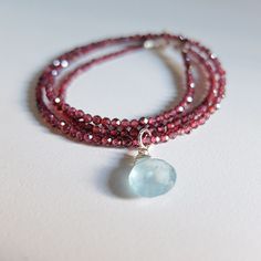 "This stunning piece  is made of tiny, genuine rhodolite garnet gemstones and one  beautiful aquamarine briolette.  I've used an unusual combination of colors. The necklace closes at  cm, 43,00  16.92\"-  The clasp and  findings are 925 silver, I can add an extender chain  It's beautiful and dramatic, still versatile for every day wear you will receive the exact necklace shown in the photos  see the matching earrings here  https://www.etsy.com/listing/525102226/rhodolite-garnet-earringsaquamarin Garnet Briolette For Jewelry Making, Luxury Briolette Jewelry With Sterling Silver Clasp, Garnet Briolette Beads For Jewelry Making, Briolette Faceted Aquamarine Jewelry, Aquamarine Faceted Briolette Jewelry, Aquamarine Briolette Faceted Jewelry, Red Briolette Gemstone Beads Jewelry, Red Briolette Necklace With Faceted Beads, Red Ruby Briolette Jewelry