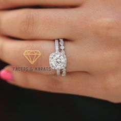 a woman's hand with a diamond ring on top of her finger and the engagement band