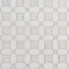 a white tiled wall with hexagonal tiles