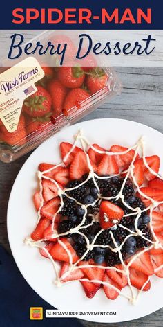 a white plate topped with strawberries and blueberries next to a container of berries