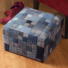 a pair of red shoes sitting on top of a wooden floor next to a foot stool