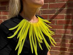 Elevate your style with this bold and unique Radiant Yellow Statement Necklace. Crafted from high-quality mesh material, this stunning piece features vibrant yellow strands radiating from a central collar, creating an eye-catching fan-like effect. Perfect for adding a pop of color to any outfit, this necklace is both lightweight and comfortable, making it ideal for special occasions or everyday wear. Stand out from the crowd and express your individuality with this avant-garde accessory. **Key F Yellow Choker Jewelry For Summer, Yellow Choker Necklace For Summer, Yellow Summer Choker Necklace, Unique Yellow Choker Necklace, Handmade Yellow Necklace For Party, Unique Yellow Necklace For Party, Large Necklace, Bib Necklaces, Necklace Statement