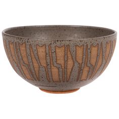 a brown and black bowl sitting on top of a table