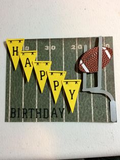 a football themed birthday card with the number forty and pennants on it, hanging from a wall