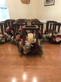 a wooden table topped with lots of flowers next to a candle holder filled with candles