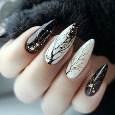 Step into a world of elegance with Artistic Wonderland Nails, featuring a striking combination of black, white, and gold. Delicate golden branches and glitter accents create a luxurious and mysterious vibe, perfect for those seeking a unique Christmas nails design that blends modern sophistication with a touch of festive magic.  #ArtisticWonderlandNails #ChristmasNails #LuxuryNailDesign #BlackAndGoldNails #HolidayNailArt #ElegantNails #FestiveNailDesign #ChicNailArt Yule Nail Art, Black And Golden Nails, Yule Nails, Unique Christmas Nails, Christmas Nails Design, Wonderland Nails, Festive Nail Designs, Nails Elegant, Chic Nail Art