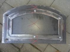 a metal frame with screws on the side of it and some red tape around it