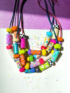 ✿ Bold & unique wearable art Utopic Color Charm Necklace ✿ Made with various shaping techniques ✿ Multicolored & textured handcrafted beads ✿ One of a kind design. Each necklace is distinct from the next ✿ Extremely durable leather cord ✿ Worldwide international shipping Whether you're planning to go to a concert, a festival, a birthday party, a night out with friends, the beach, or the supermarket, delicately handcrafted Utopic Color Charm Necklace adds a unique touch to your outfit! Artistic Handmade Beaded Necklaces For Festivals, Artsy Handmade Beaded Necklaces For Festivals, Handmade Artsy Beaded Necklace For Festivals, Artistic Handmade Beaded Necklace For Festival, Artistic Multicolor Necklaces With Large Beads, Handmade Polymer Clay Playful Necklaces, Handmade Playful Polymer Clay Necklaces, Artistic Multicolor Beaded Necklaces, Playful Jewelry With Colorful Beads For Crafting