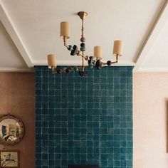 a living room with a fireplace and blue tiled walls