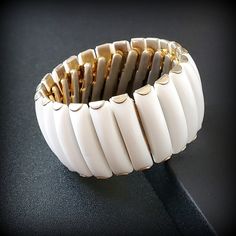 Vintage white thermoset Wide expandable bracelet Vintage gold white cuff bracelet small size 6 1/2'' Metal - Gold-tone Ston: white thermoset panels Size -  small 6 1/4'', wide1 1/4'' Mark - Hong Kong Around the 1950s -1960s Condition - good condition PLEASE NOTE: Vintage jewelry can show signs of wear and discoloration or chipped metal consistent with age. Please look at the pictures carefully. Most were purchased at estate sales, auctions, etc. so they could need cleaning. If you need additional pictures or have questions, please contact me prior to purchase. I am not a jeweler or an expert. I do the best I can to research and represent the items. Also on auction purchases, I use the information I get from the auction houses. If you have any questions or need additional pictures, please l White Flexible Bracelet For Formal Occasions, Adjustable White Bangle For Formal Occasions, Flexible White Bangle Bracelet, White Adjustable Flexible Bracelets, Adjustable Flexible White Bracelets, Adjustable White Flexible Bracelets, White Adjustable Bangle Cuff Bracelet, Adjustable White Cuff Bangle Bracelet, White Bangle Cuff Bracelet For Formal Occasions