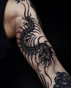 a man with a dragon tattoo on his arm