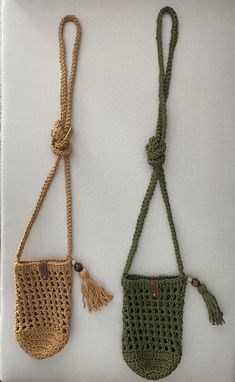 two crocheted purses with tasseled handles