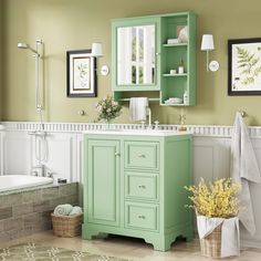 a bathroom with green cabinets and white walls