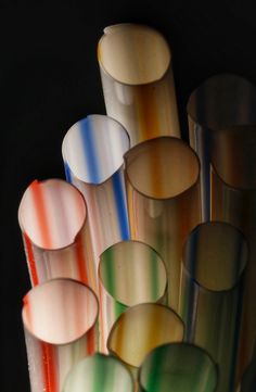 many different colored vases are stacked together