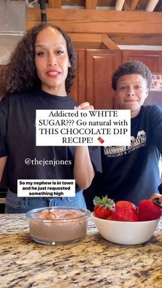 a man and woman standing behind a counter holding up a sign that says sugar - go natural with this chocolate dip