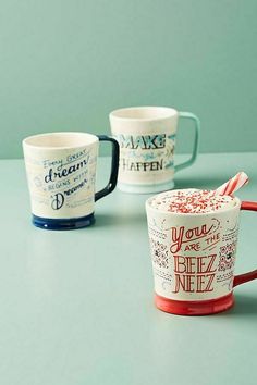 three coffee mugs sitting on top of a table