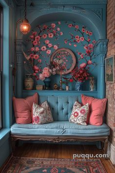 a blue couch with pink flowers on the wall