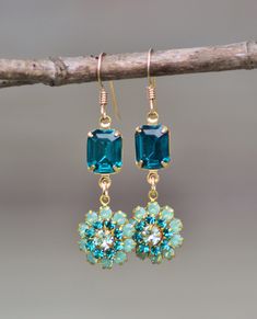 "Amazing new earrings made using premium flower components and Swarovski crystal. Earrings feature a floral component, set with pacific opal, teal blue, and clear crystal. Stones are all prong set and connect to an octagon shaped jewel in dark teal blue. Earrings connect to a 14K gold filled french ear wire. Earrings are just a hair under 2\" long. VERY limited supply vintage flowers.   Nickel and lead free." Turquoise Flower Earrings, Oak Leaf Earrings, Blue Wedding Jewelry, Ethiopian Opal Necklace, Teal Earrings, Blue Green Gold, Teal Flowers, Vintage Style Earrings, Sparkle Earrings