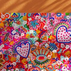 a colorful painting with hearts and flowers on it