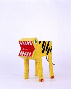 an elephant made out of construction paper with its mouth open and eyes wide open, sitting on a white surface