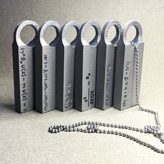 six metal objects with chains attached to them