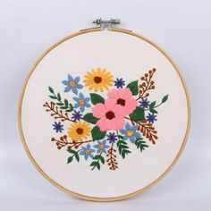 an embroidered flower arrangement on a white background