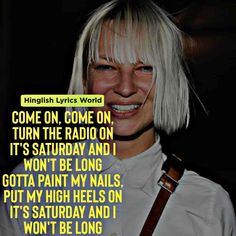 a woman with blonde hair and bangs smiles at the camera while wearing a white shirt