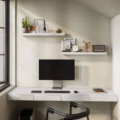 a white desk with a computer monitor and keyboard sitting on top of it next to a window