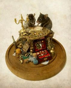 two mouses sitting on top of a table surrounded by other items and decor pieces