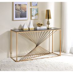 a gold console table with black marble top in a living room or dining room area