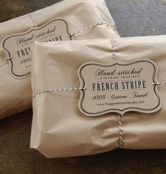 two packages of french stripe soap sitting on top of each other, wrapped in twine