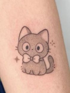 a small cat with a bow tie tattoo on the arm and leg, it looks like he is holding something in his hand