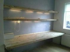 an empty room with some shelves on the wall and a light bulb hanging from the ceiling