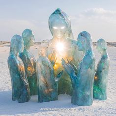 a group of people standing in the snow next to each other with their hands together